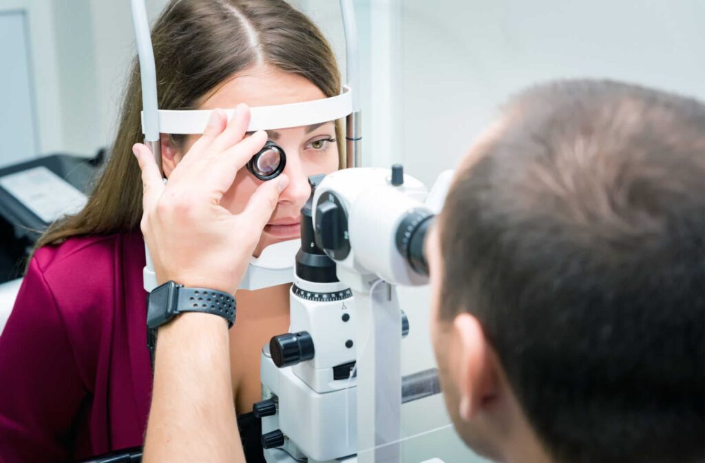 A woman getting her eyes examined by an eye doctor during her regular routine eye exam